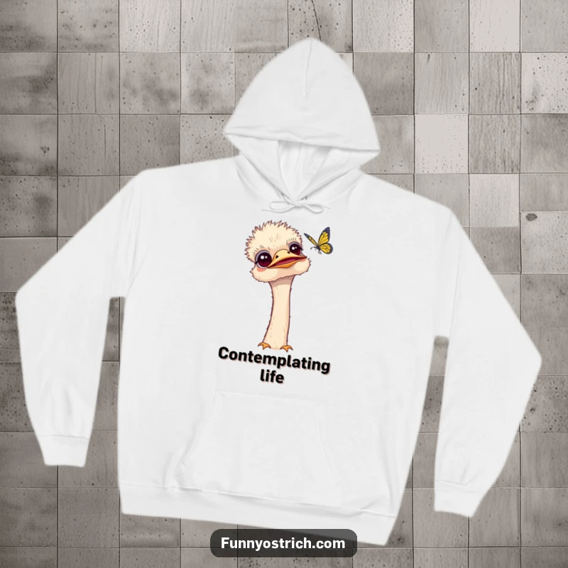 Funny kawaii ostrich hoodie showing a curious ostrich tilting its head to observe a fluttering butterfly. Cozy and thoughtful.