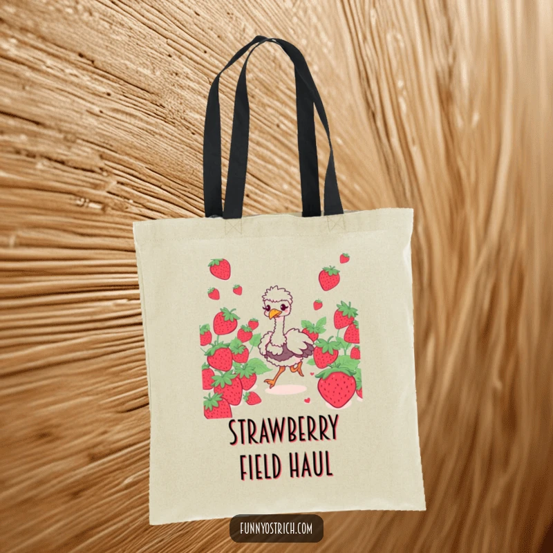 Funny ostrich character with a giggling expression prancing through oversized strawberries on a tote bag, great for shopping.